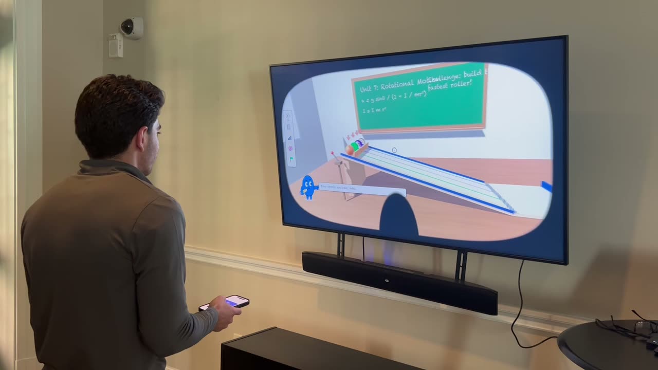 A student driving ScribbleVu with a phone in front of a TV